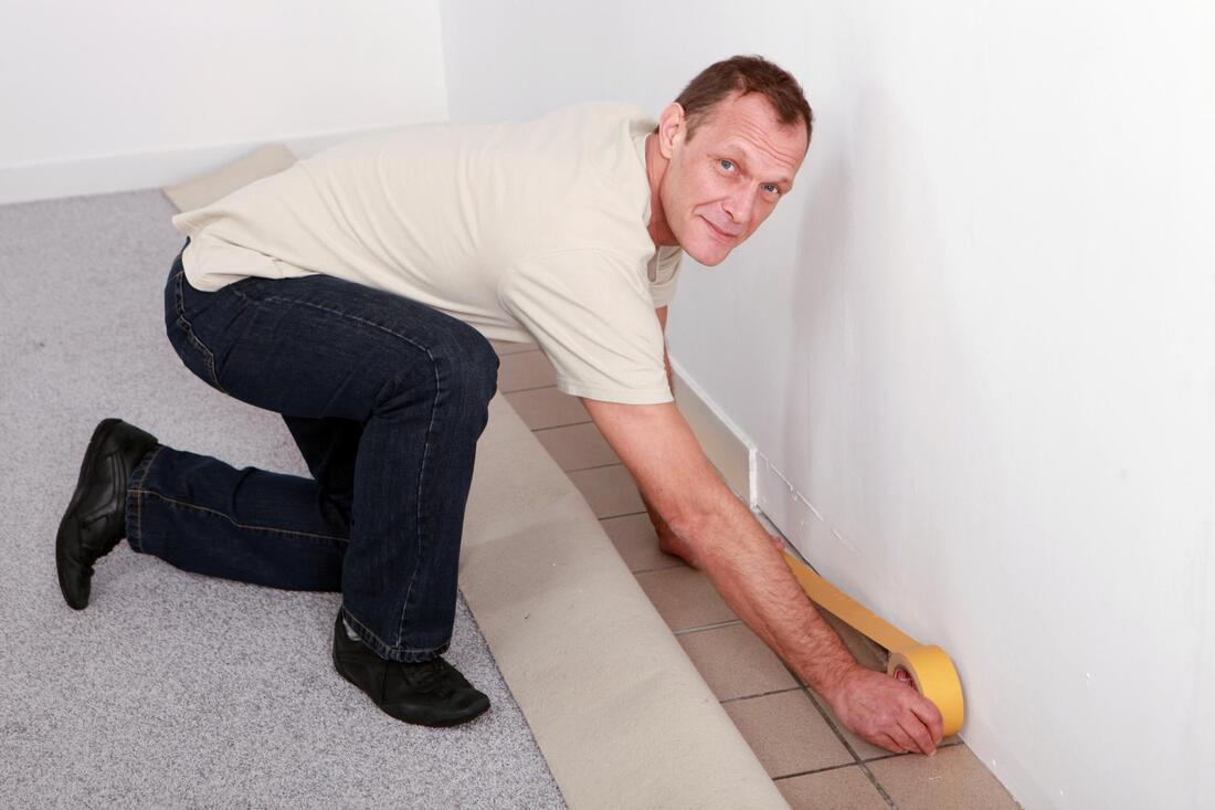 man installing a carpet